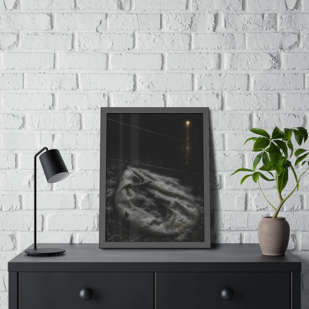 A deflated pool float under snow beside a chain link fence at night. The Bleaching Under Snow by Garabaggio, framed fine art print hanging in a room.