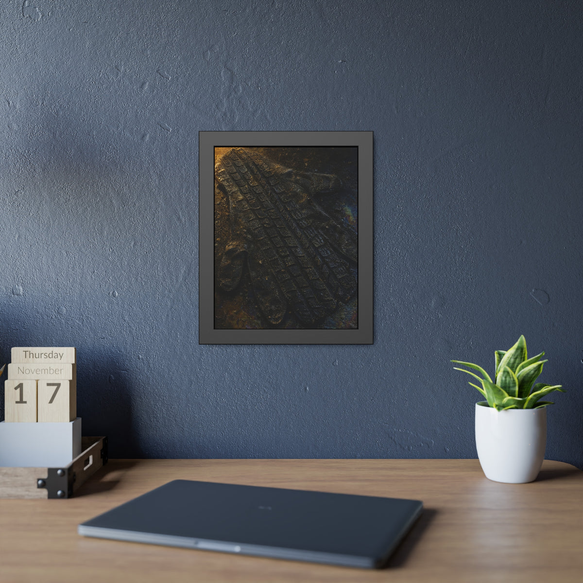 A flattened work glove on asphalt with a tire tread pressed across it. The Passage of the Wheel by Garabaggio, framed fine art print hanging in a room.