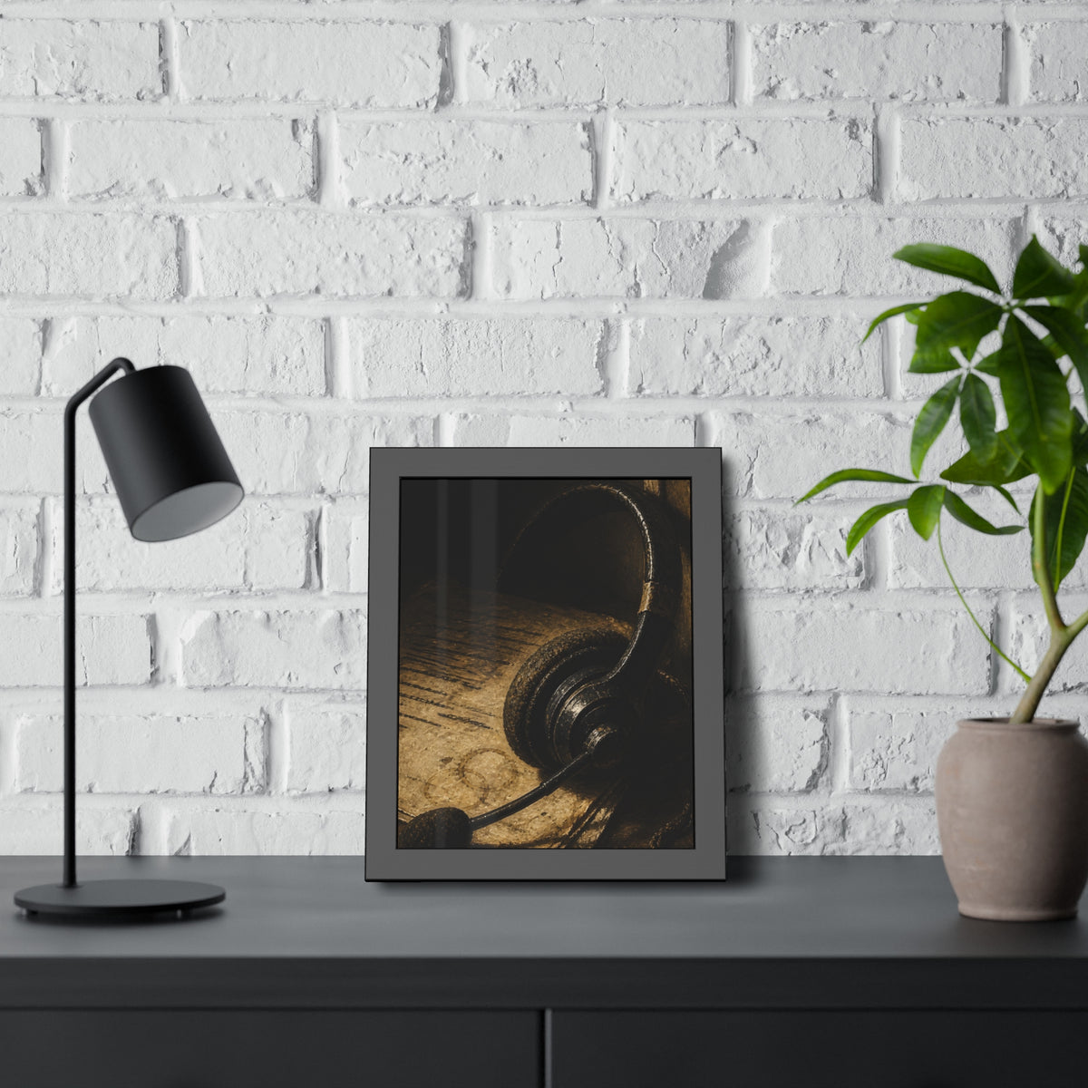A worn headset resting on a printed script page with coffee rings. The Script Beside the Mouthpiece by Garabaggio, framed fine art print hanging in a room.