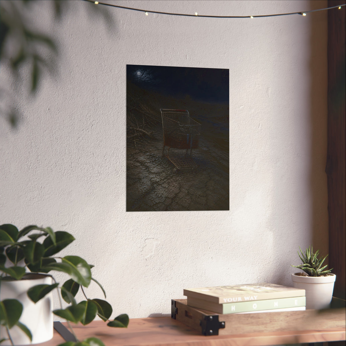A rusted shopping cart sunk in cracked dried mud under a full moon. The Silting by Garabaggio, fine art print hanging in a room.