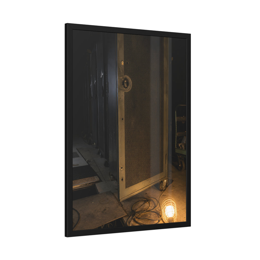 A perforated server rack door in a dark aisle lit by a floor work lamp. The Cold Aisle by Garabaggio, framed fine art print hanging in a room.