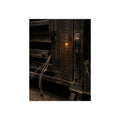 A single amber light among green LEDs on a grimy server rack. The Amber Fault by Garabaggio, fine art print, 12″ x 16″.