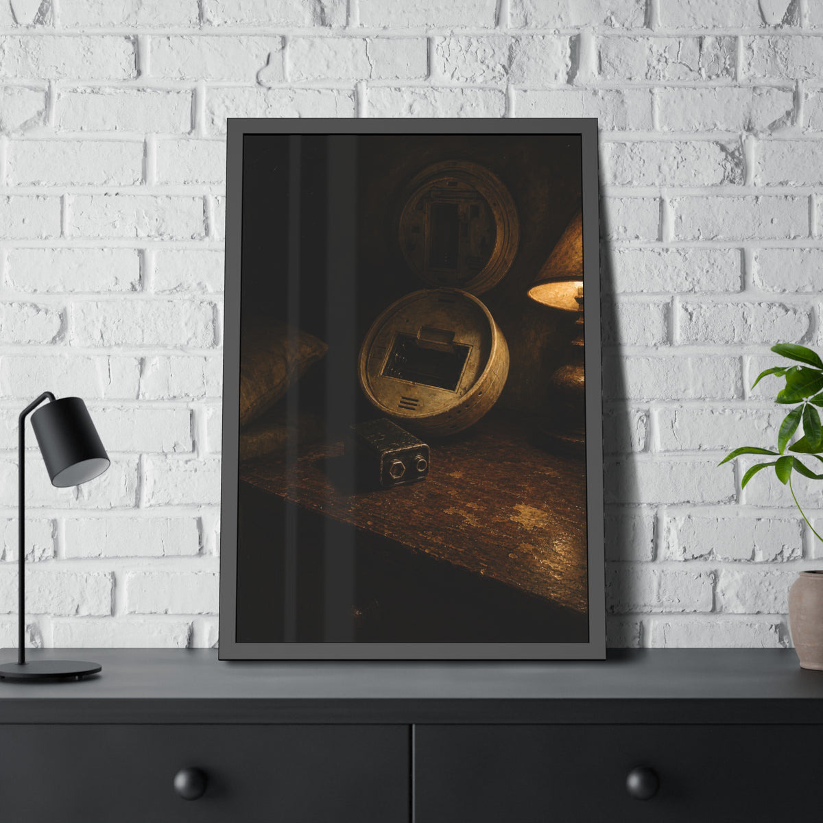 An open smoke detector on a wooden table beside a removed nine volt battery. The Silence After Removal by Garabaggio, framed fine art print hanging in a room.