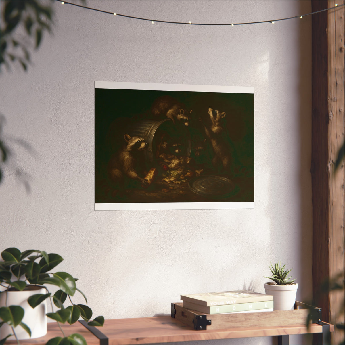 Raccoons around a tipped metal trash can, scattering food scraps. The Vigil of the Midnight Feast by Garabaggio, fine art print hanging in a room.