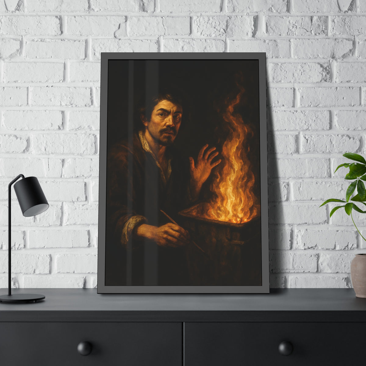 Man holding a paintbrush, his other hand raised beside tall flames. Self-Portrait with Brush and Flame by Garabaggio, framed fine art print hanging in a room.