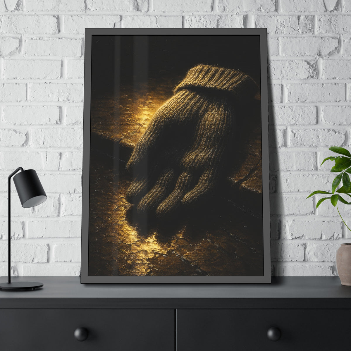A knitted wool glove palm down on wet stone in gold light. The Presentation of the Woolen Glove by Garabaggio, framed fine art print hanging in a room.