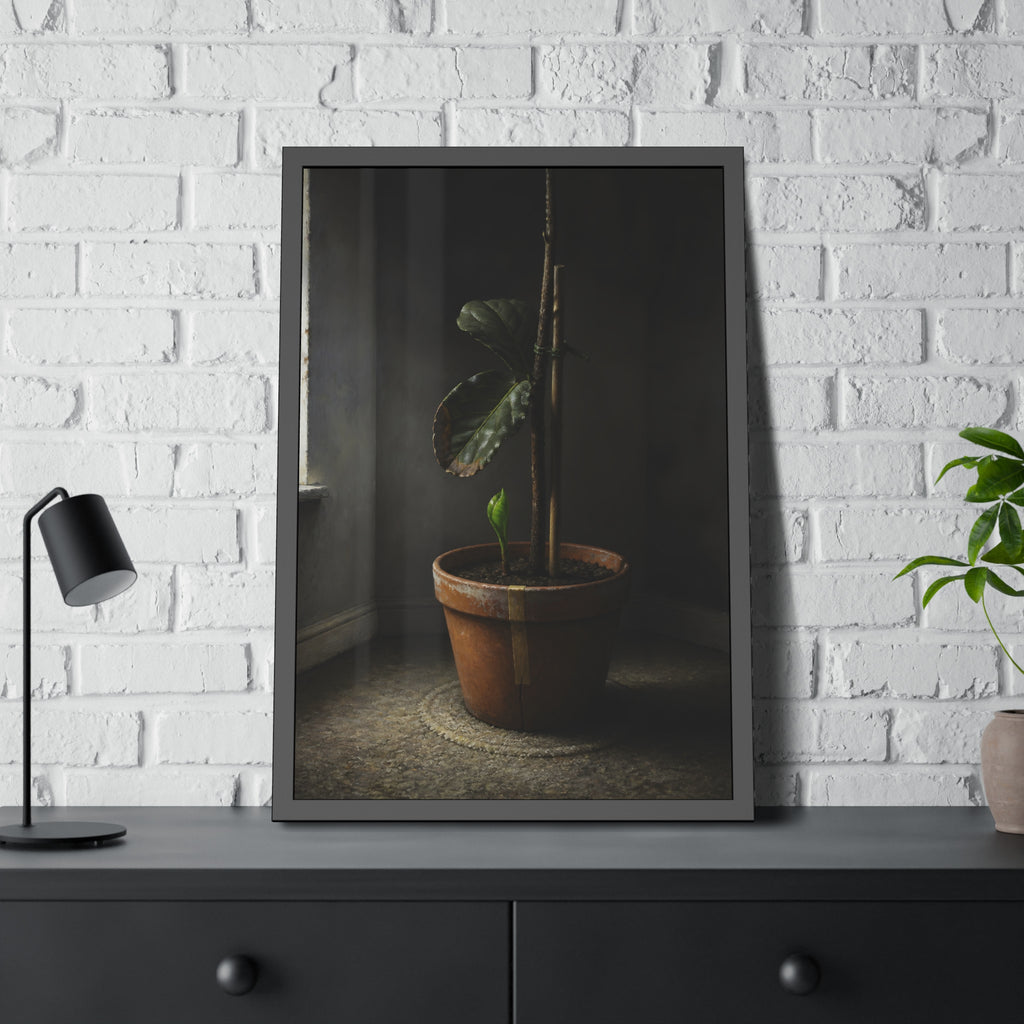 A potted plant down to two curled leaves and one new sprout by a window. The Corner by the Window Again by Garabaggio, framed fine art print hanging in a room.