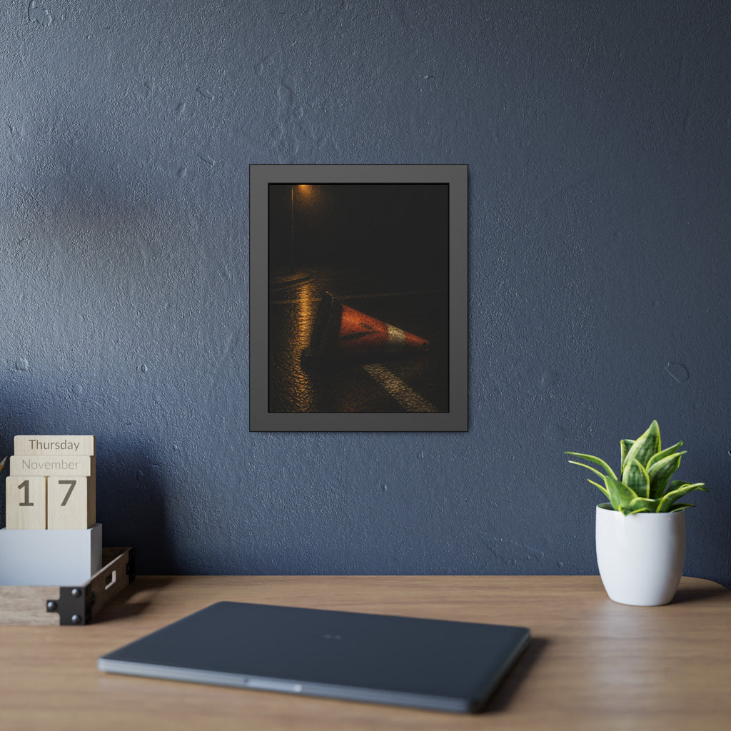 A toppled orange traffic cone on a wet road under a lone streetlight. The Taking by the Bumper by Garabaggio, framed fine art print hanging in a room.