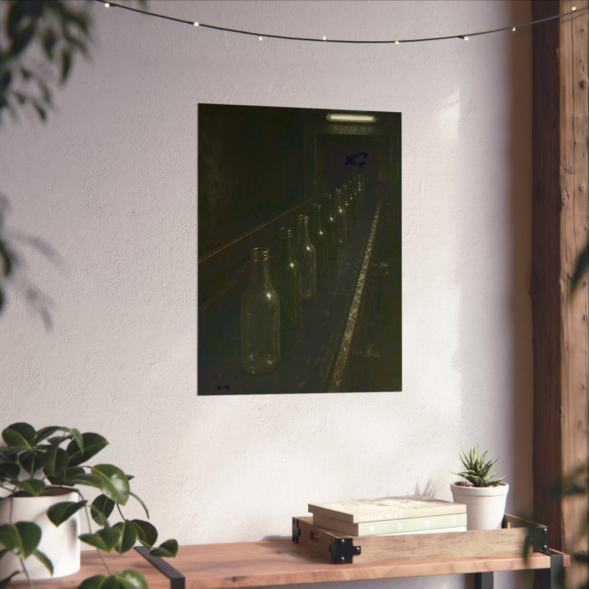 Empty glass bottles in a line on a conveyor under one fluorescent tube. The Procession of Bottles by Garabaggio, fine art print hanging in a room.