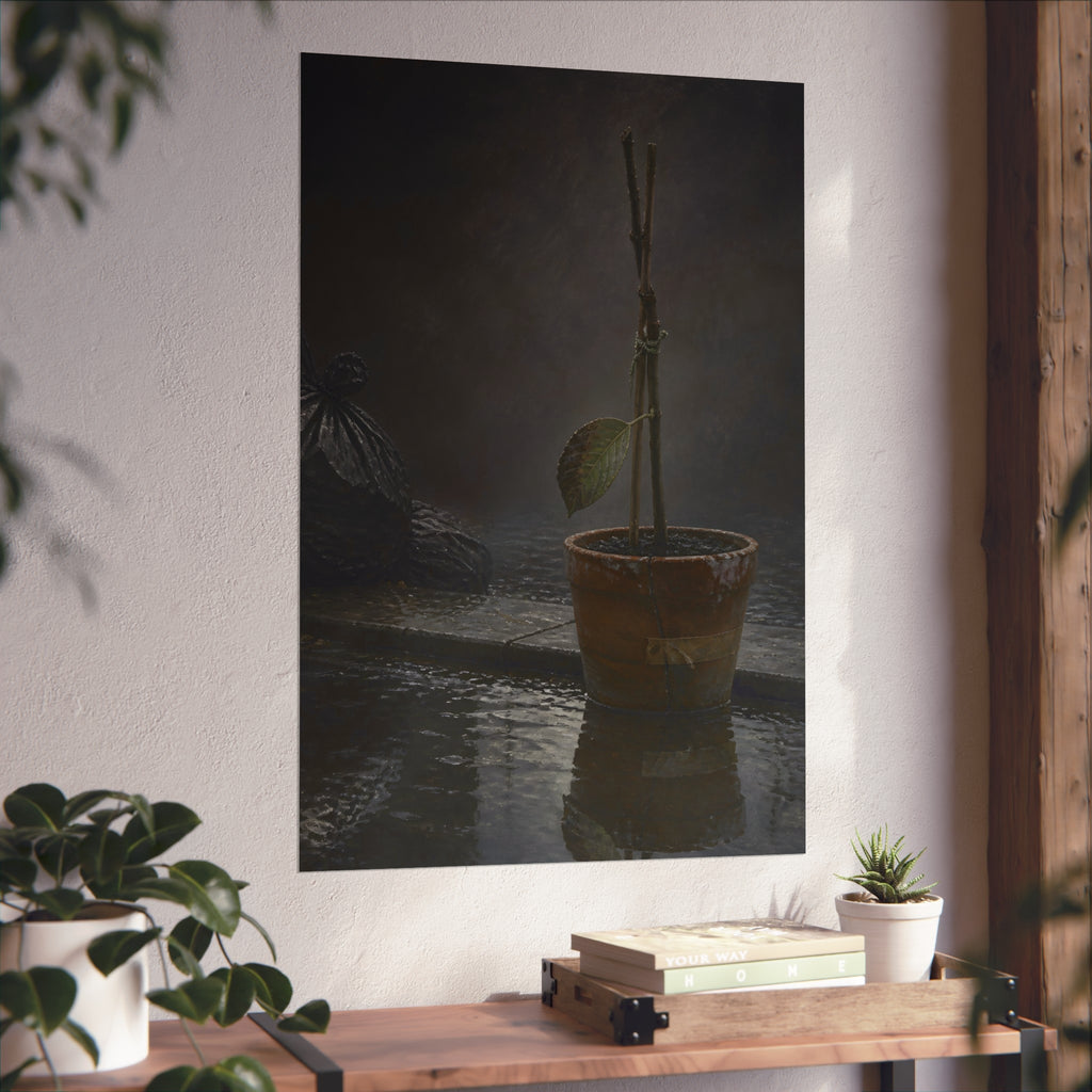 Bare tied stems in a clay pot on flooded pavement, one leaf remaining. The Grey Between by Garabaggio, fine art print hanging in a room.