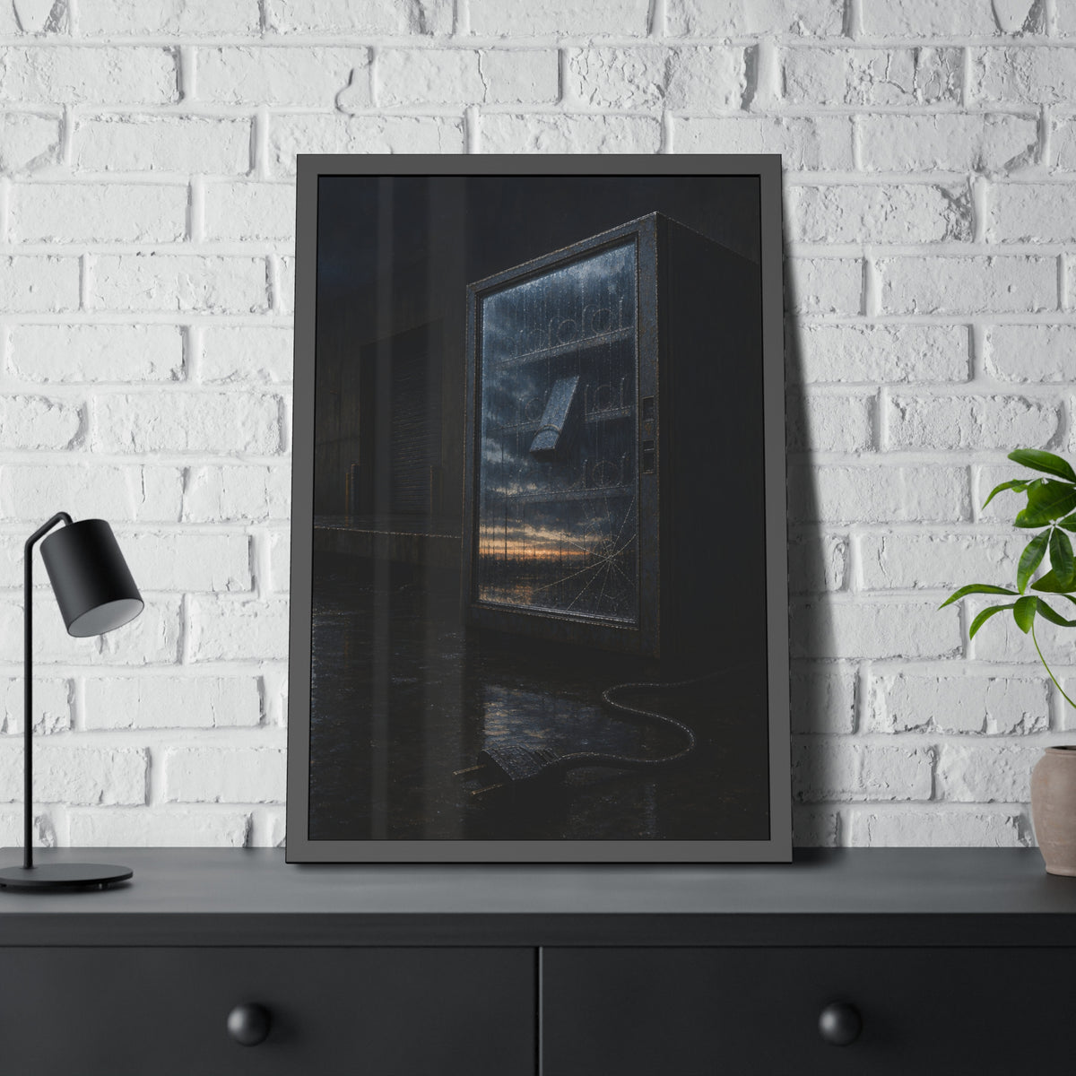 Empty vending machine with cracked glass reflecting dawn on a wet lot. Dawn in the Dead Glass by Garabaggio, framed fine art print hanging in a room.