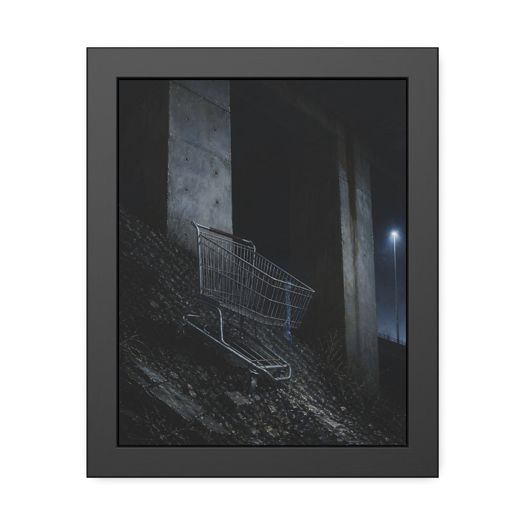 A shopping cart on a rocky slope under an overpass near a streetlamp. The Descent to the Underpass by Garabaggio, framed fine art print, 11″ x 14″.