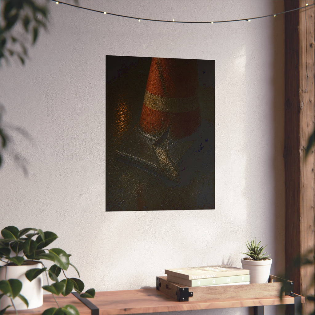 An orange traffic cone with a split base on wet asphalt at night. The Splitting of the Base by Garabaggio, fine art print hanging in a room.