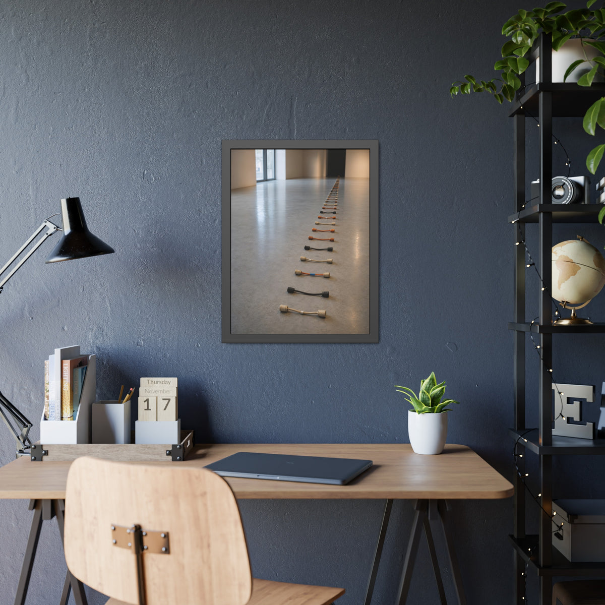 A long line of cut extension cord ends laid across a pale gallery floor. The Severed Procession by Garabaggio, framed fine art print hanging in a room.