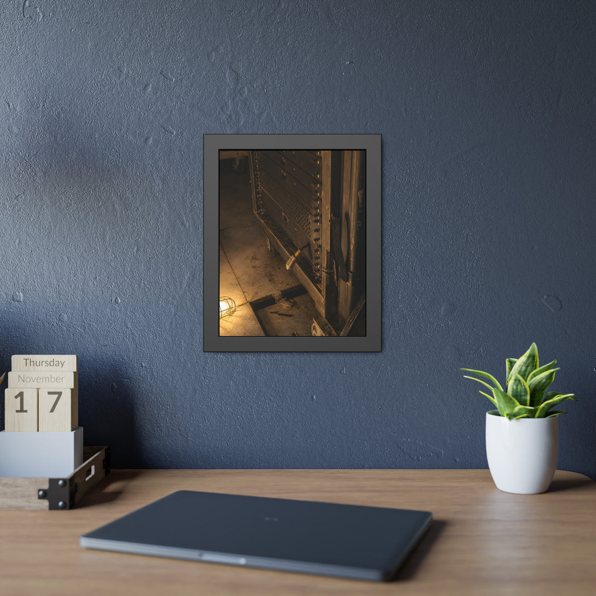 A server rack on a concrete floor beside a caged work light. The Silence at Cutover by Garabaggio, framed fine art print hanging in a room.