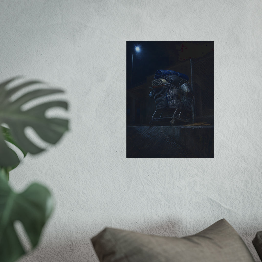 A shopping cart piled with bedding and buckets under a streetlamp. The Loading of Another Life by Garabaggio, fine art print hanging in a room.