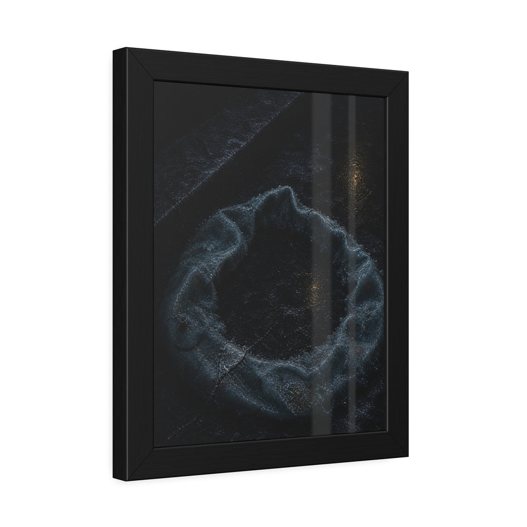 A deflated ring float collapsed on wet pavement under distant amber light. The Freezing of the Smile by Garabaggio, framed fine art print hanging in a room.