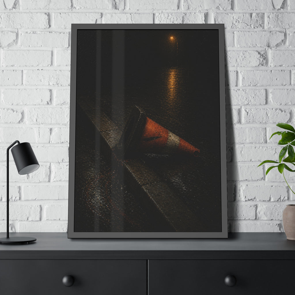 An orange traffic cone toppled on a wet curb under a distant streetlamp. The Dragging Through Rain by Garabaggio, framed fine art print hanging in a room.