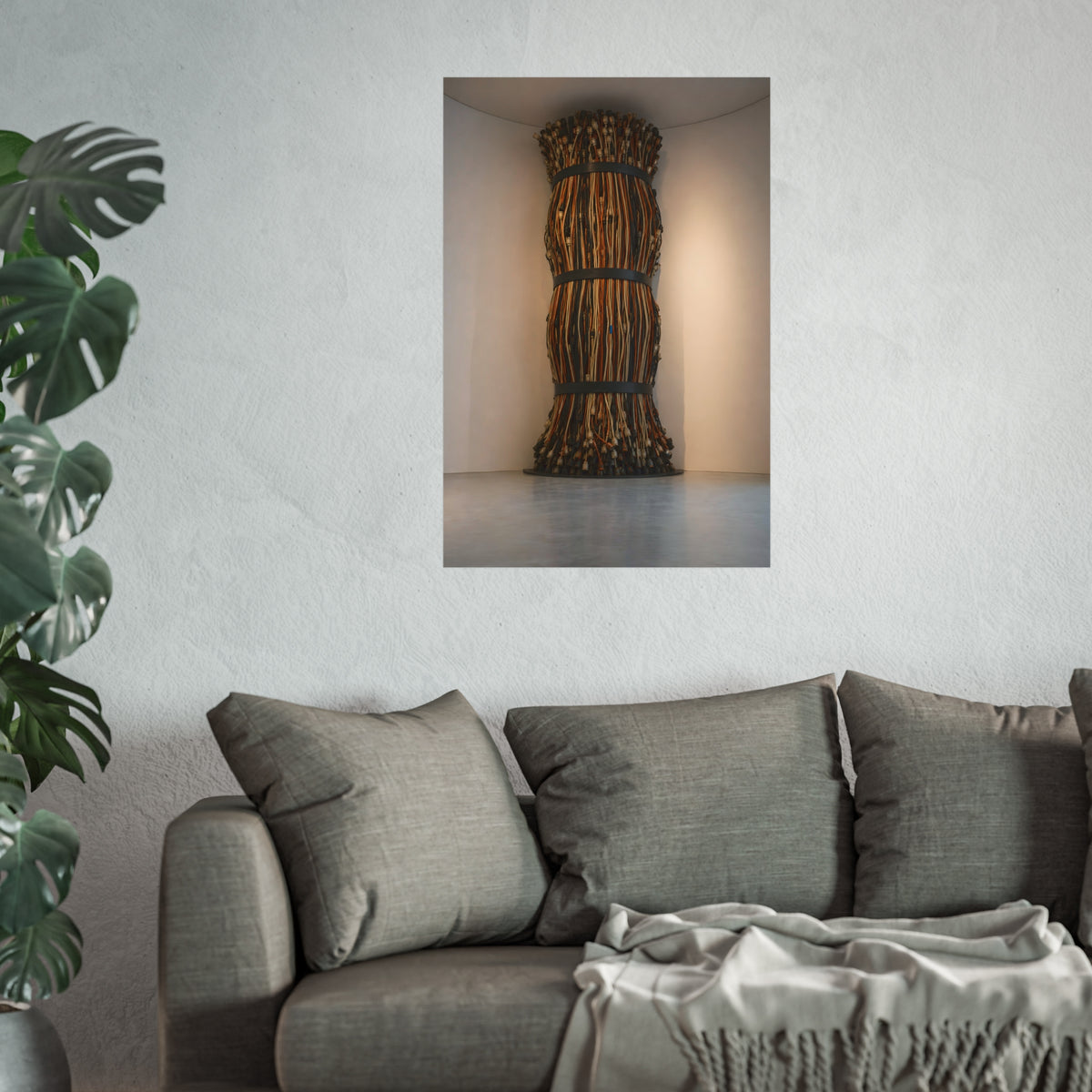 A tall column of bundled cords strapped in three places in a gallery corner. The Bundled Apse by Garabaggio, fine art print hanging in a room.