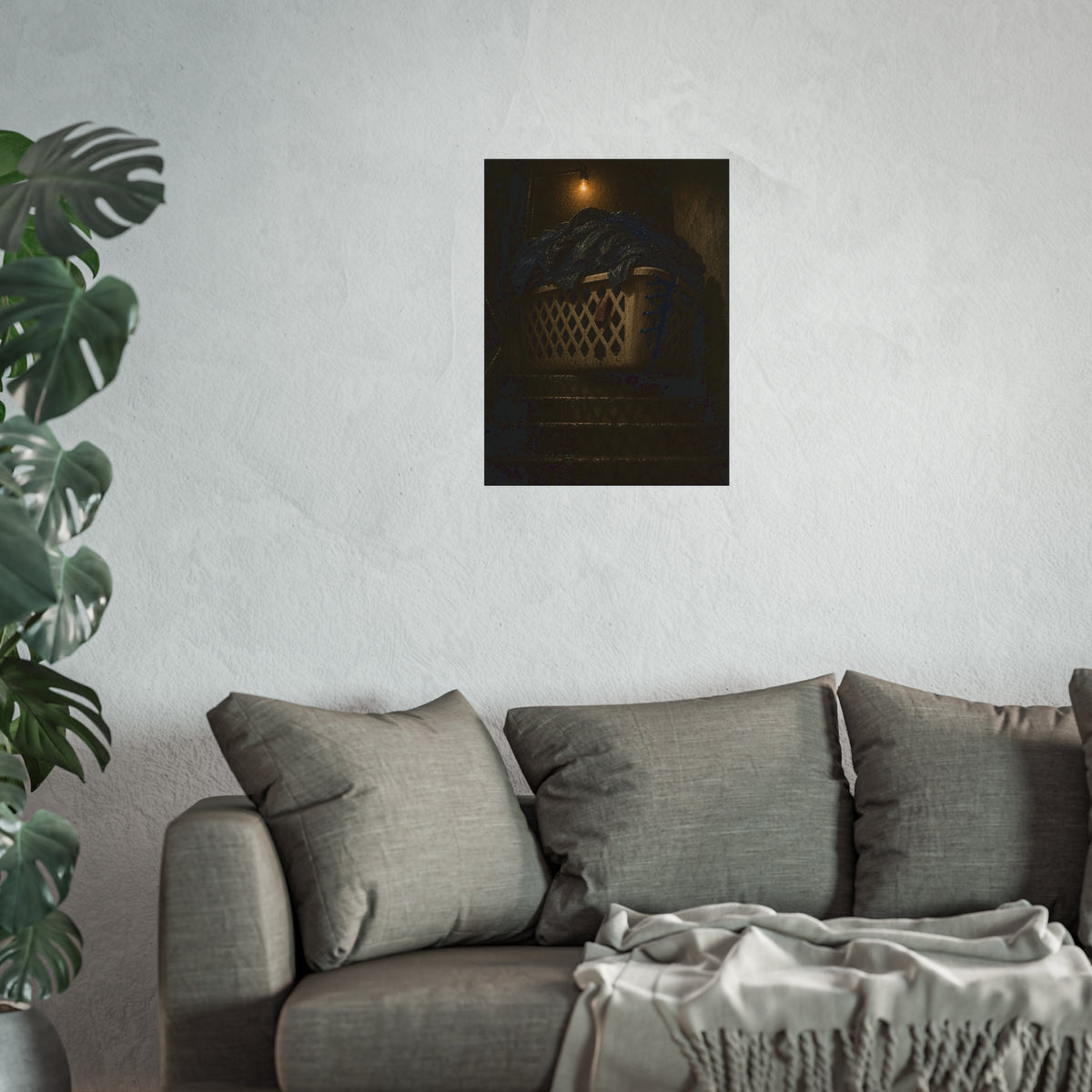 A laundry basket heaped with clothes on stairs under a bare bulb. The Overload on the Basement Stairs by Garabaggio, fine art print hanging in a room.