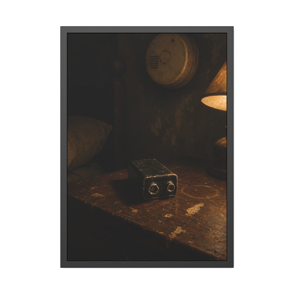 A nine volt battery on a nightstand below a wall smoke detector. The Battery Laid Below by Garabaggio, framed fine art print, 28″ x 40″.