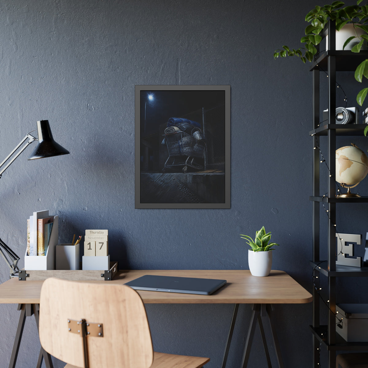 A shopping cart piled with bedding and buckets under a streetlamp. The Loading of Another Life by Garabaggio, framed fine art print hanging in a room.