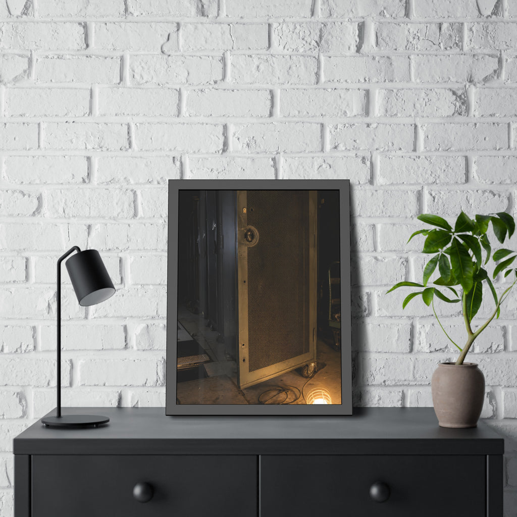 A perforated server rack door in a dark aisle lit by a floor work lamp. The Cold Aisle by Garabaggio, framed fine art print hanging in a room.