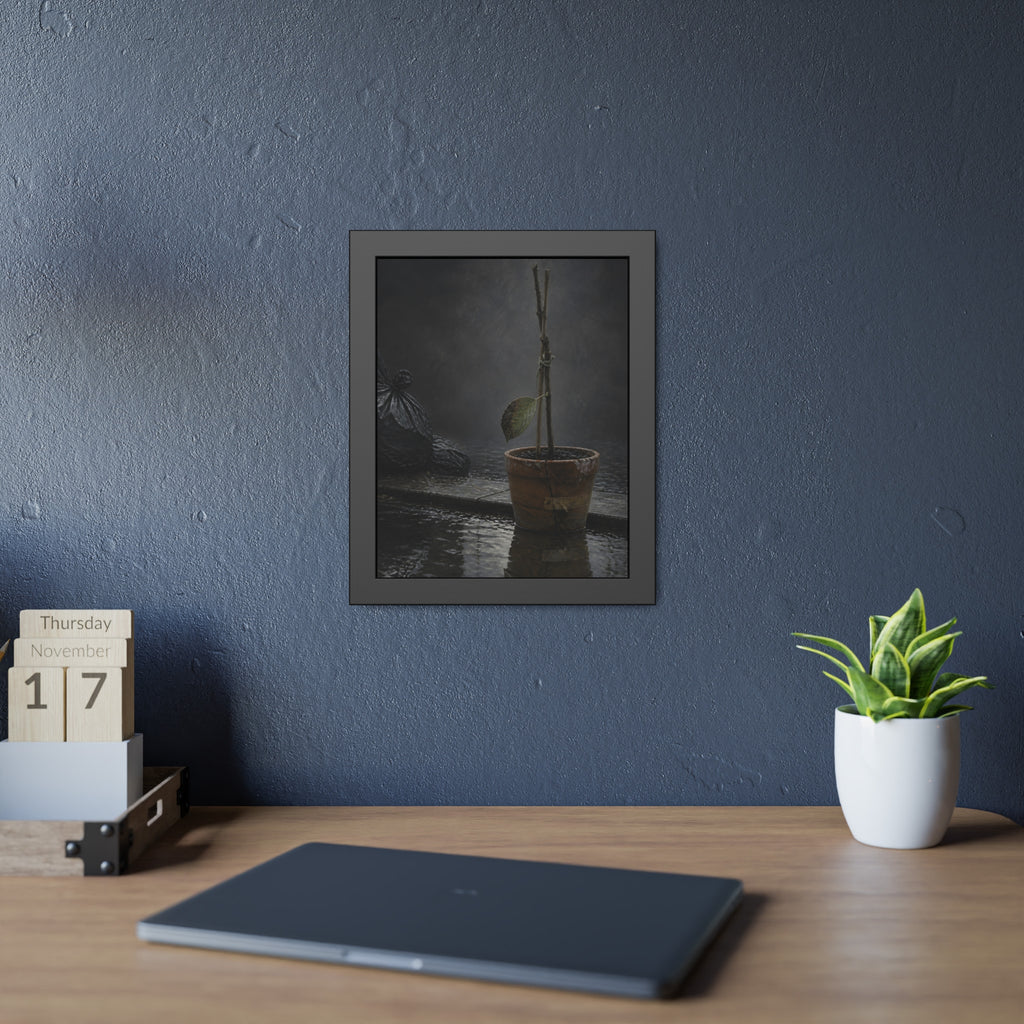 Bare tied stems in a clay pot on flooded pavement, one leaf remaining. The Grey Between by Garabaggio, framed fine art print hanging in a room.