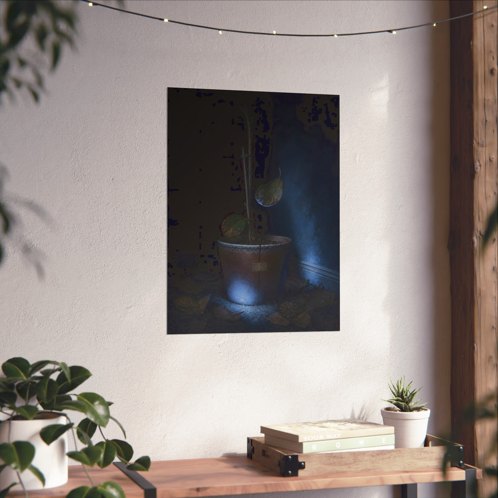 A bare potted plant dropping a leaf, dead leaves on the floor. The Leaf Lets Go by Garabaggio, fine art print hanging in a room.