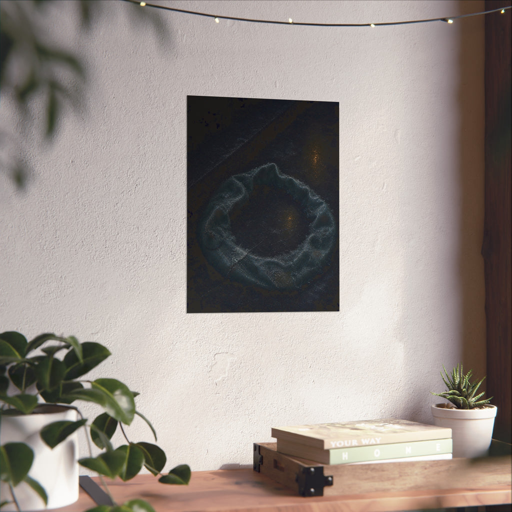 A deflated ring float collapsed on wet pavement under distant amber light. The Freezing of the Smile by Garabaggio, fine art print hanging in a room.