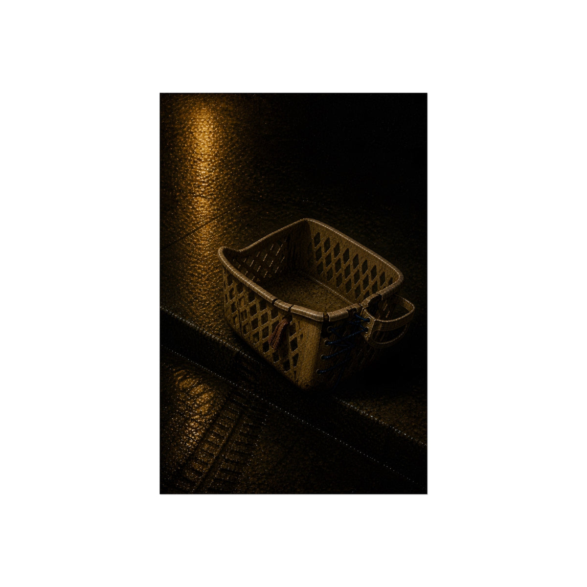 A cracked plastic laundry basket with a warped rim on wet asphalt. The Crushing of the Rim by Garabaggio, fine art print, 24″ x 36″.
