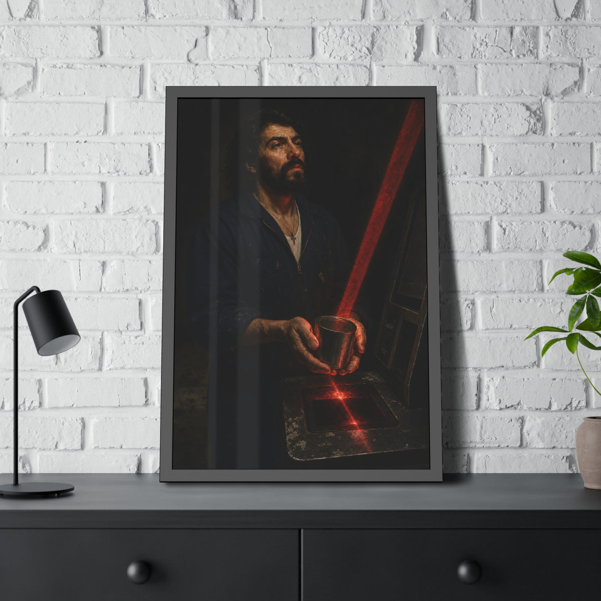 A man in blue coveralls holding a metal cup in a red scanner beam. The First Scan by Garabaggio, framed fine art print hanging in a room.
