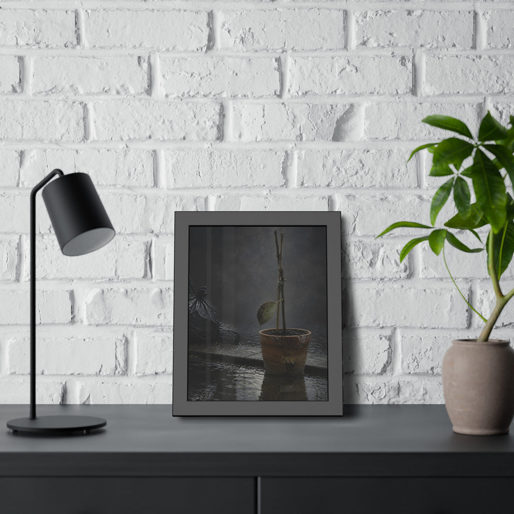 Bare tied stems in a clay pot on flooded pavement, one leaf remaining. The Grey Between by Garabaggio, framed fine art print hanging in a room.