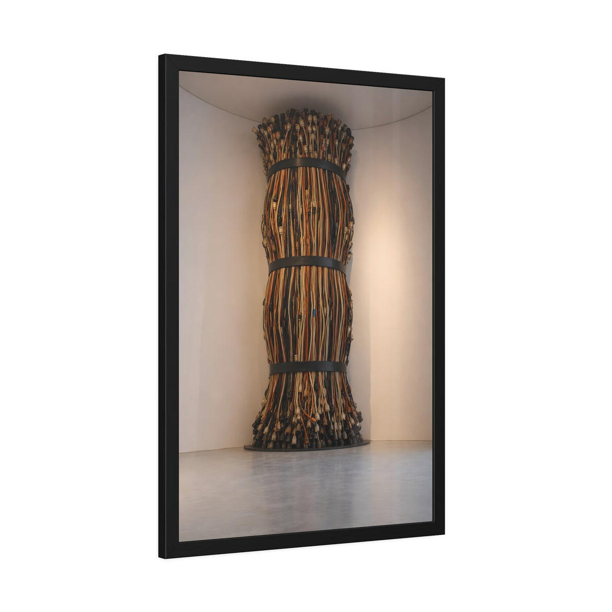 A tall column of bundled cords strapped in three places in a gallery corner. The Bundled Apse by Garabaggio, framed fine art print hanging in a room.