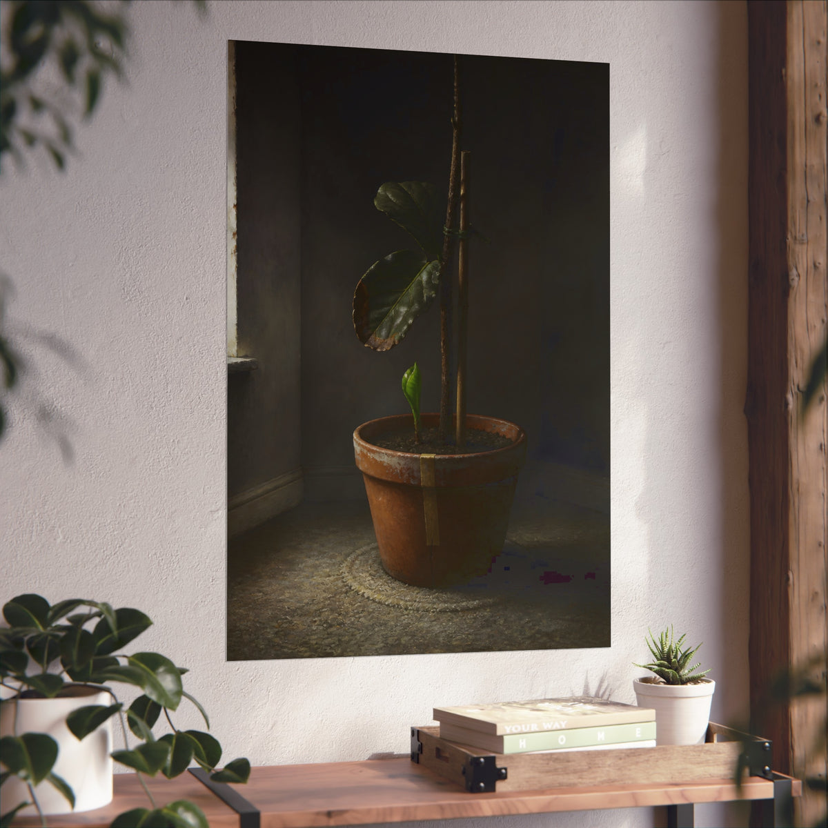 A potted plant down to two curled leaves and one new sprout by a window. The Corner by the Window Again by Garabaggio, fine art print hanging in a room.