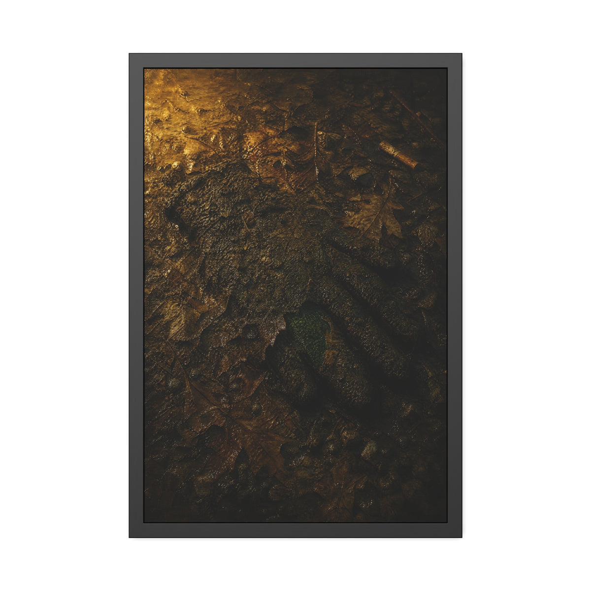 Wet mud and pressed oak leaves with a green scrap barely showing. The Reliquary of Mud and Leaf by Garabaggio, framed fine art print hanging in a room.