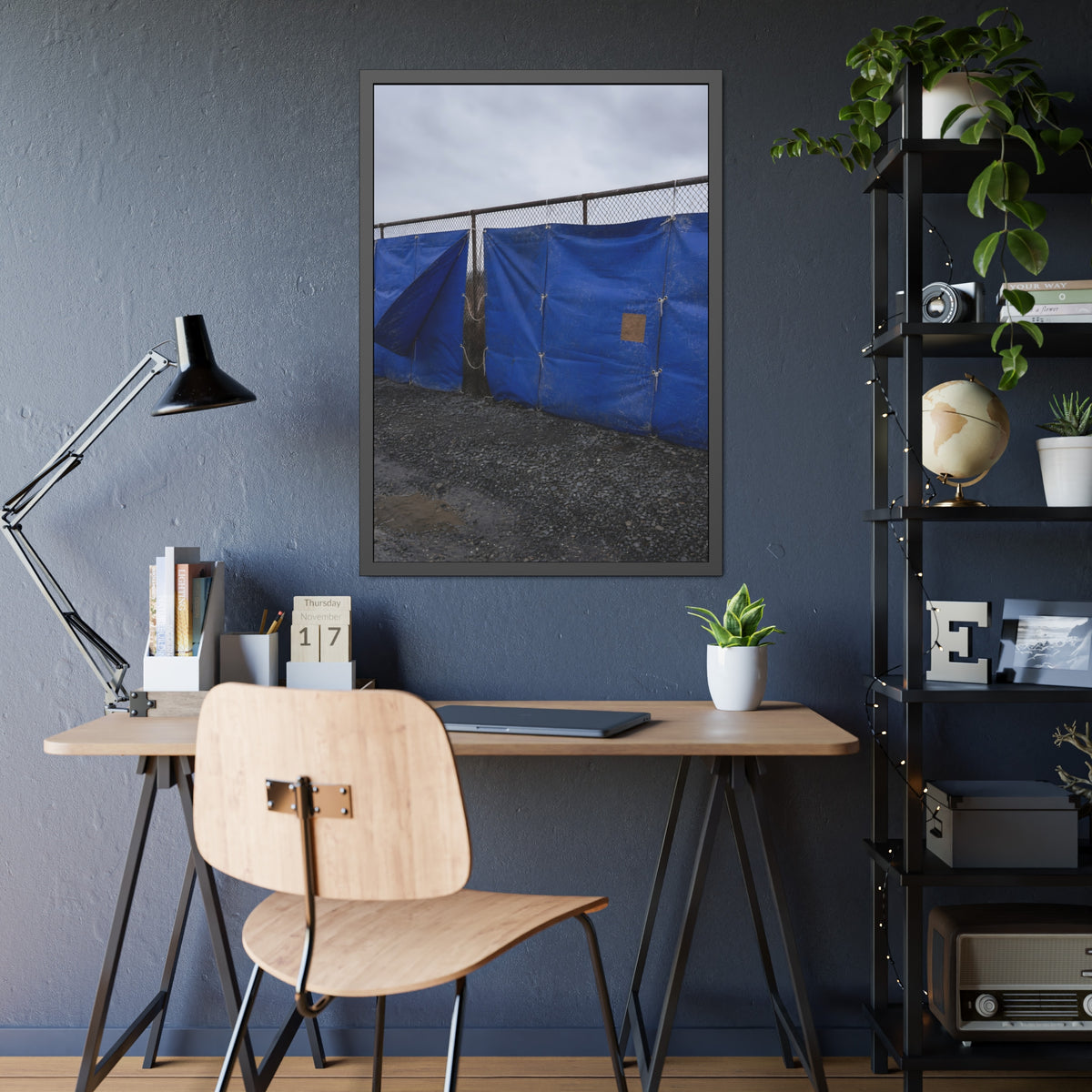 Blue tarps lashed to a chain link fence above gravel under grey sky. Drapery on the Fence by Garabaggio, framed fine art print hanging in a room.