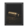A corroded AA battery lying on a dark gritty surface in a single beam. The First Exhaustion by Garabaggio, framed fine art print, 11″ x 14″.