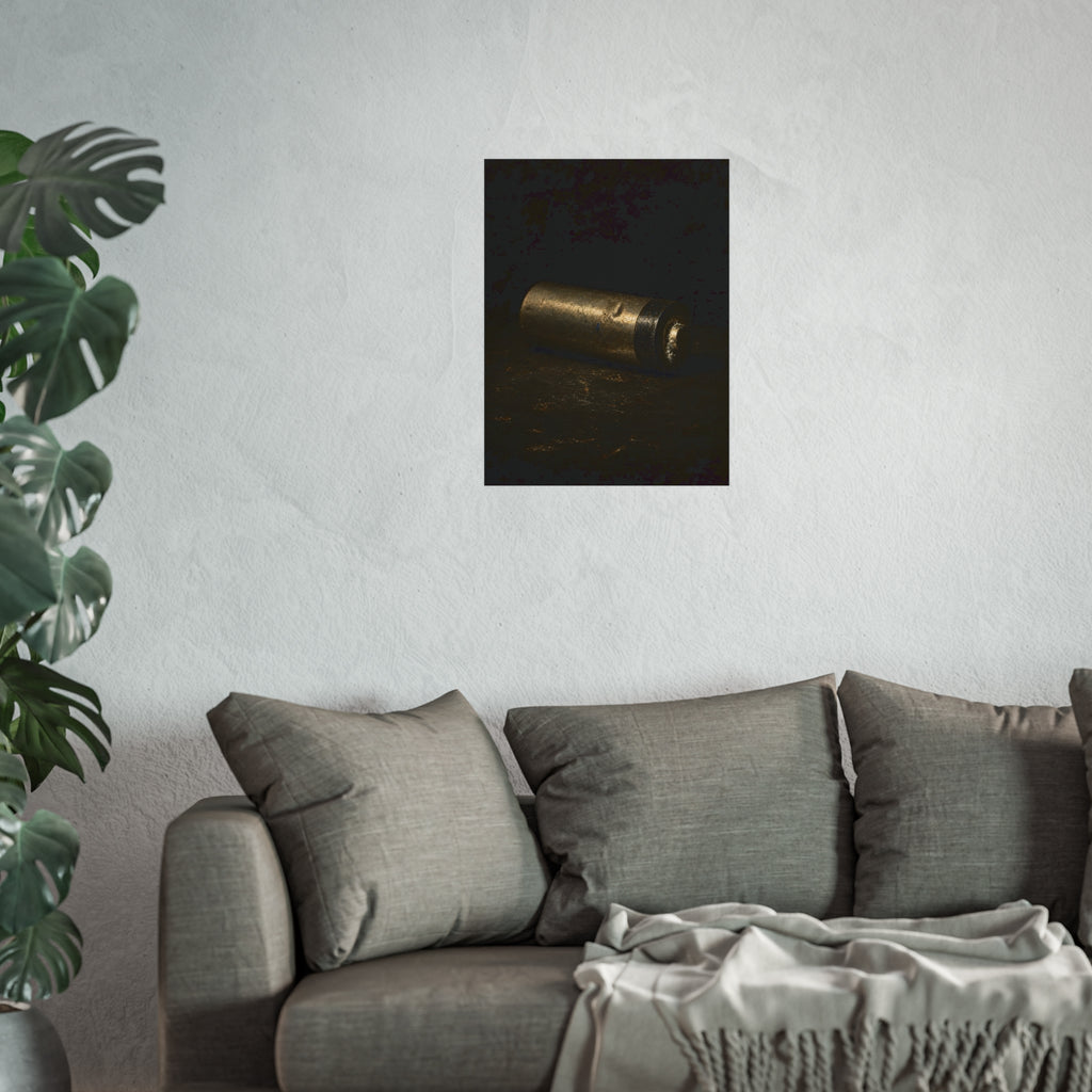 A corroded AA battery lying on a dark gritty surface in a single beam. The First Exhaustion by Garabaggio, fine art print hanging in a room.