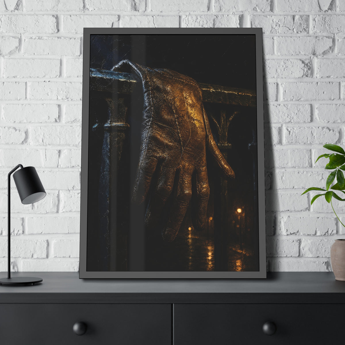 A leather glove draped over an iron railing, fingers hanging. The Repose of the Leather Glove, No. 1 by Garabaggio, framed fine art print hanging in a room.
