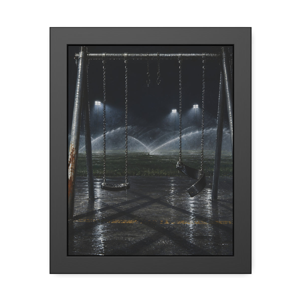 An empty swing set on wet asphalt, sprinklers arcing over the field. The Eleventh Hour: The Sprinklers by Garabaggio, framed fine art print, 11″ x 14″.