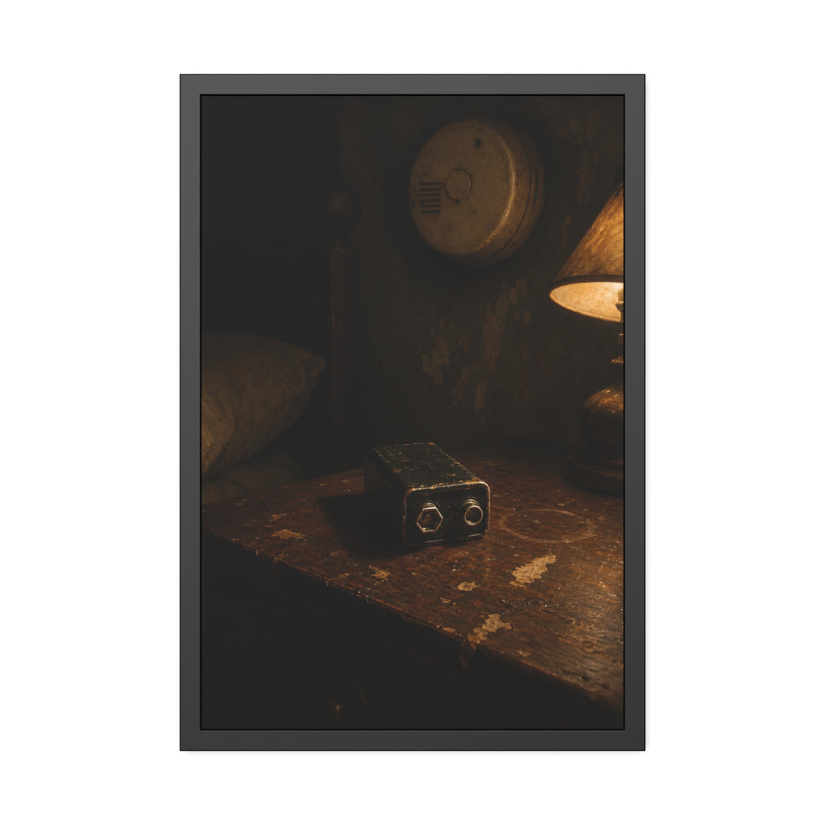 A nine volt battery on a nightstand below a wall smoke detector. The Battery Laid Below by Garabaggio, framed fine art print, 24″ x 36″.