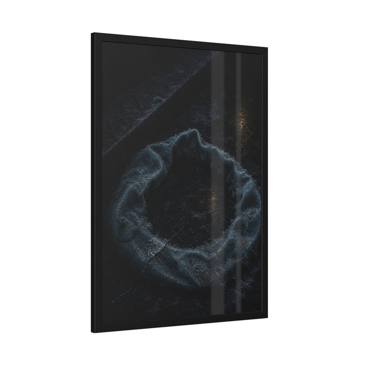 A deflated ring float collapsed on wet pavement under distant amber light. The Freezing of the Smile by Garabaggio, framed fine art print hanging in a room.