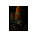 An orange traffic cone with a split base on wet asphalt at night. The Splitting of the Base by Garabaggio, fine art print, 12″ x 16″.