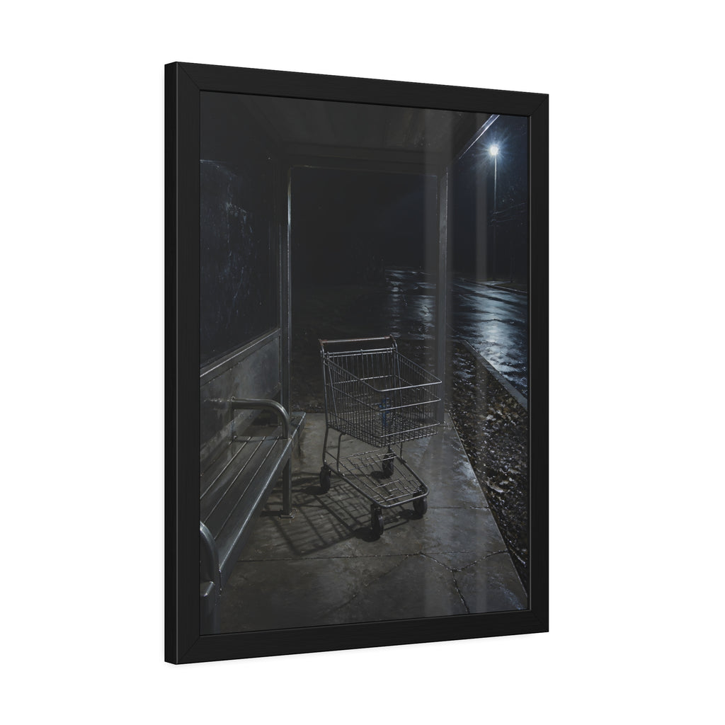 A shopping cart parked inside a bus shelter under a street lamp at night. The Rest at the Bus Shelter by Garabaggio, framed fine art print hanging in a room.