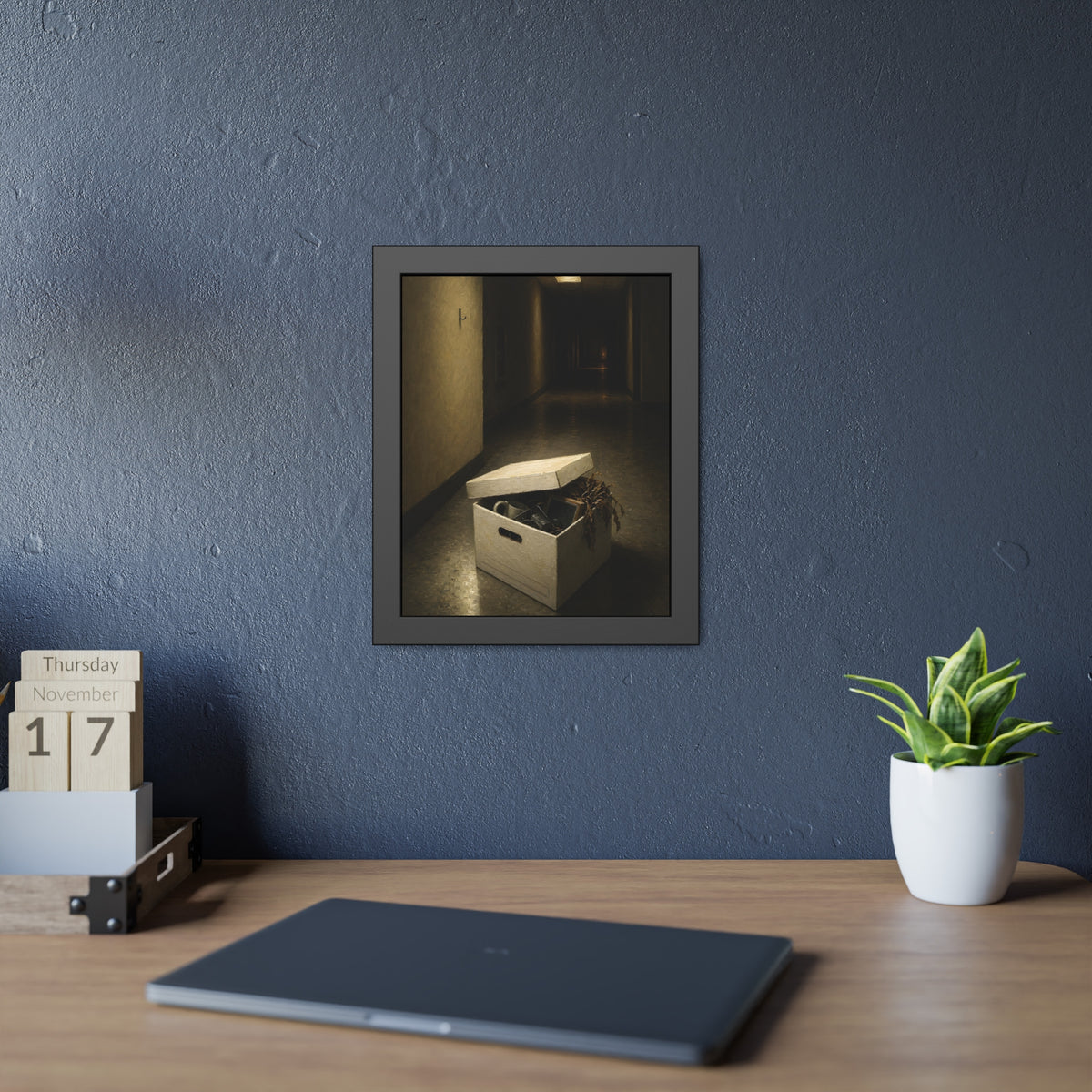 An open box of desk items on the floor of a dim office hallway. The Box of Personal Effects by Garabaggio, framed fine art print hanging in a room.