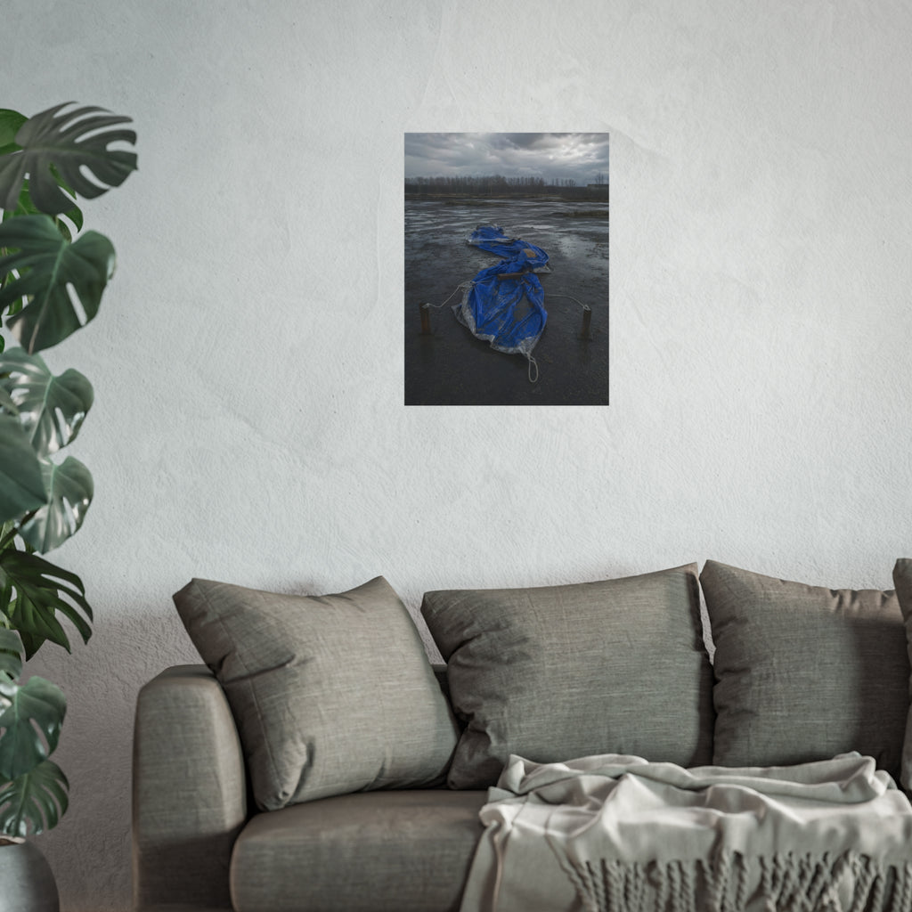 Collapsed blue tarp roped between two posts on wet cracked ground. Collapse Under Wind by Garabaggio, fine art print hanging in a room.