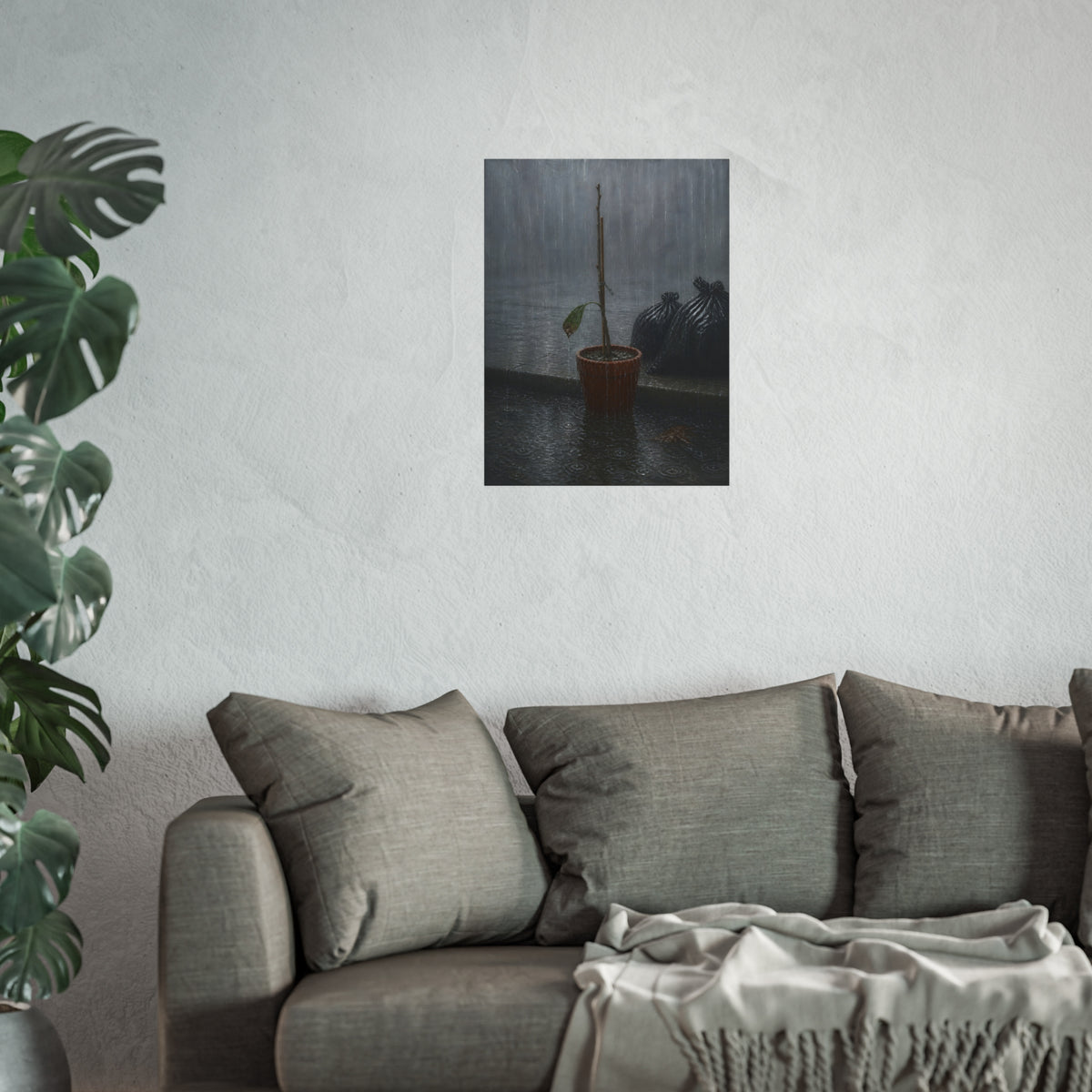 A bare stick in a clay pot on a curb in heavy rain beside trash bags. The Second Rain by Garabaggio, fine art print hanging in a room.