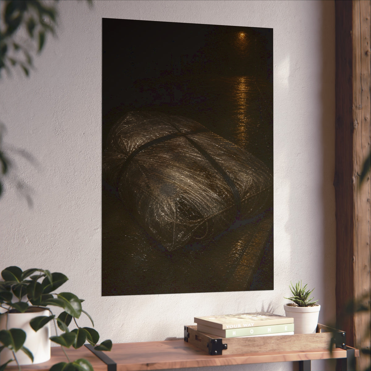 A mattress wrapped in plastic and strapped shut on a wet night street. The Municipal Shroud by Garabaggio, fine art print hanging in a room.