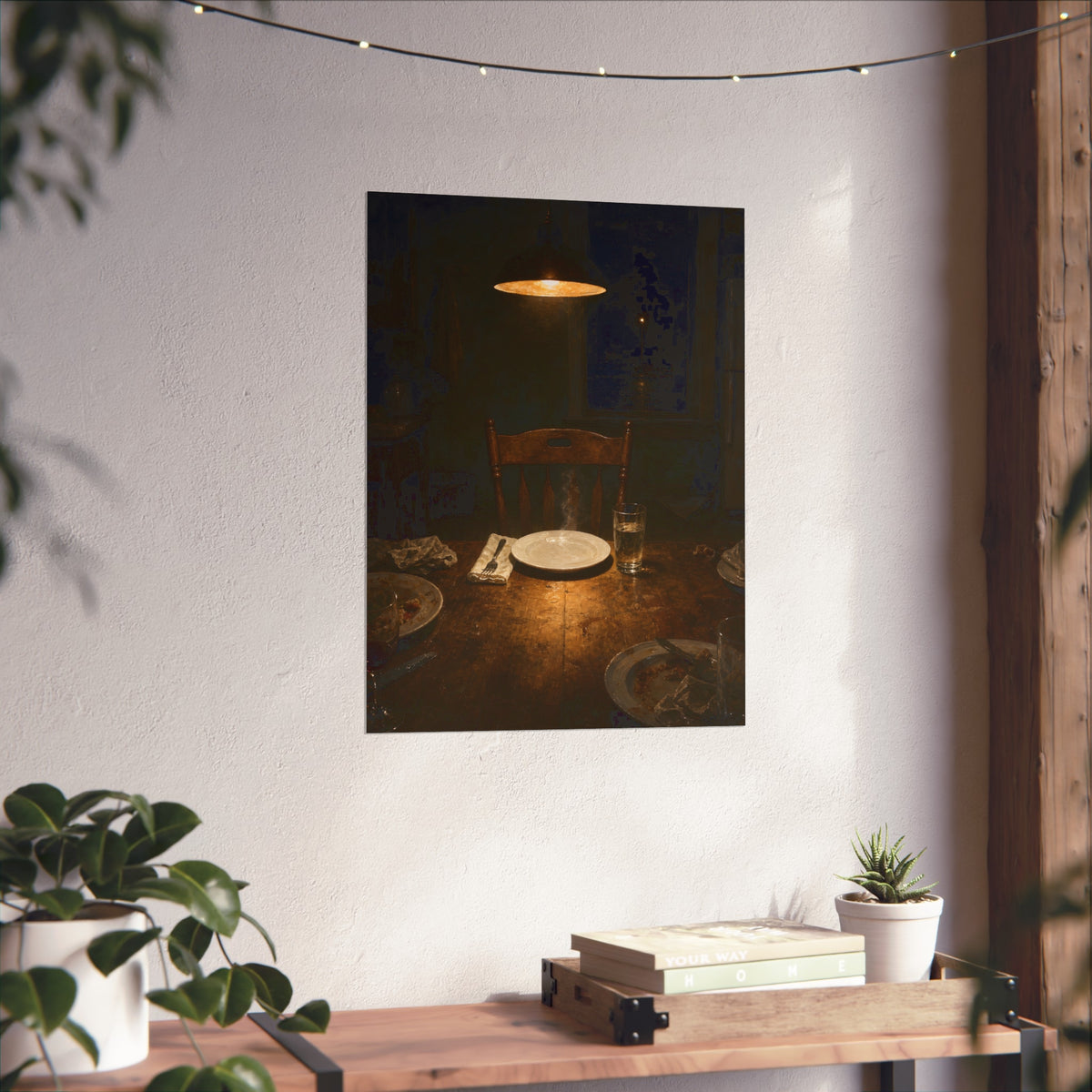 A clean plate and empty chair under a hanging lamp at a used dinner table. The Empty Seat at Dinner by Garabaggio, fine art print hanging in a room.
